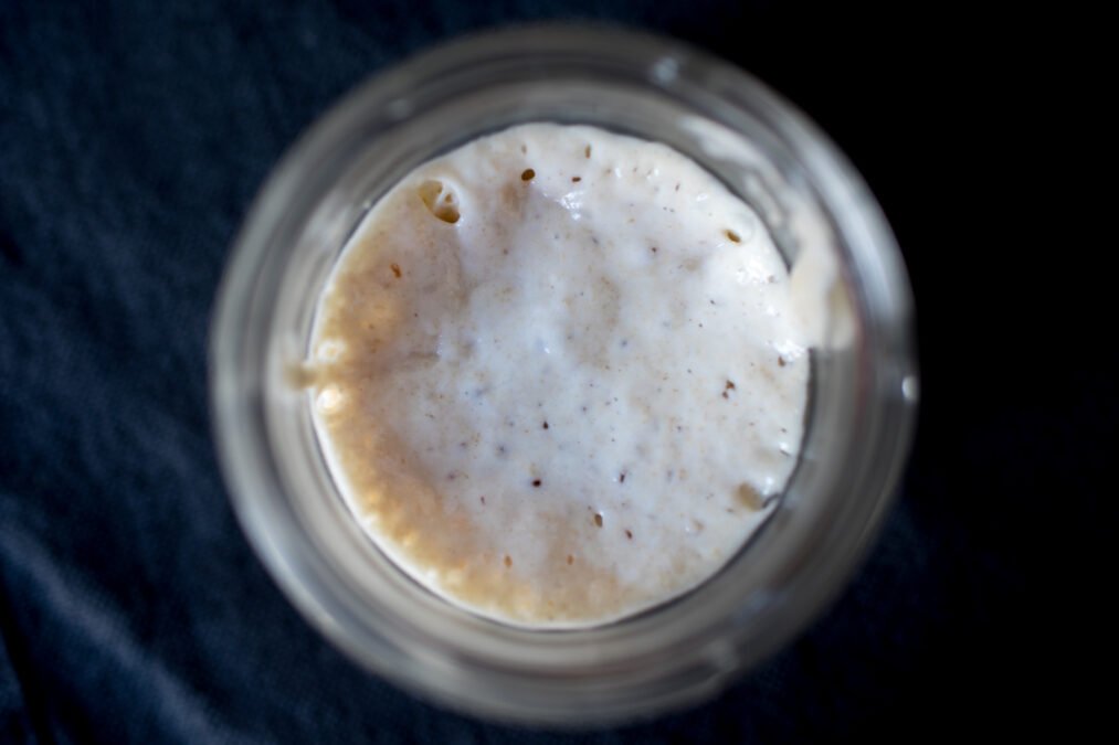 is sourdough bread good for you Sourdough starter bubbling in a glass jar