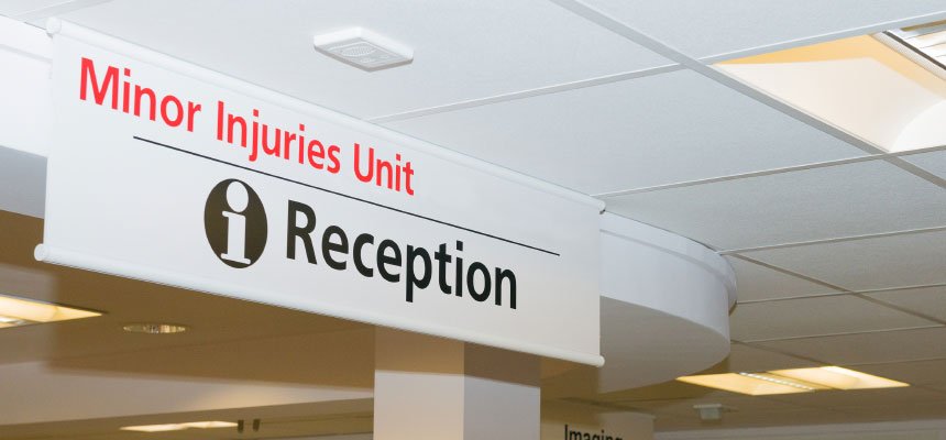 Modern minor injuries unit reception with triage desk and waiting area